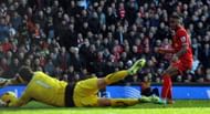 Liverpool's Raheem Sterling scores his team's second goal past Cardiff City's Scottish goalkeeper David Marshall.